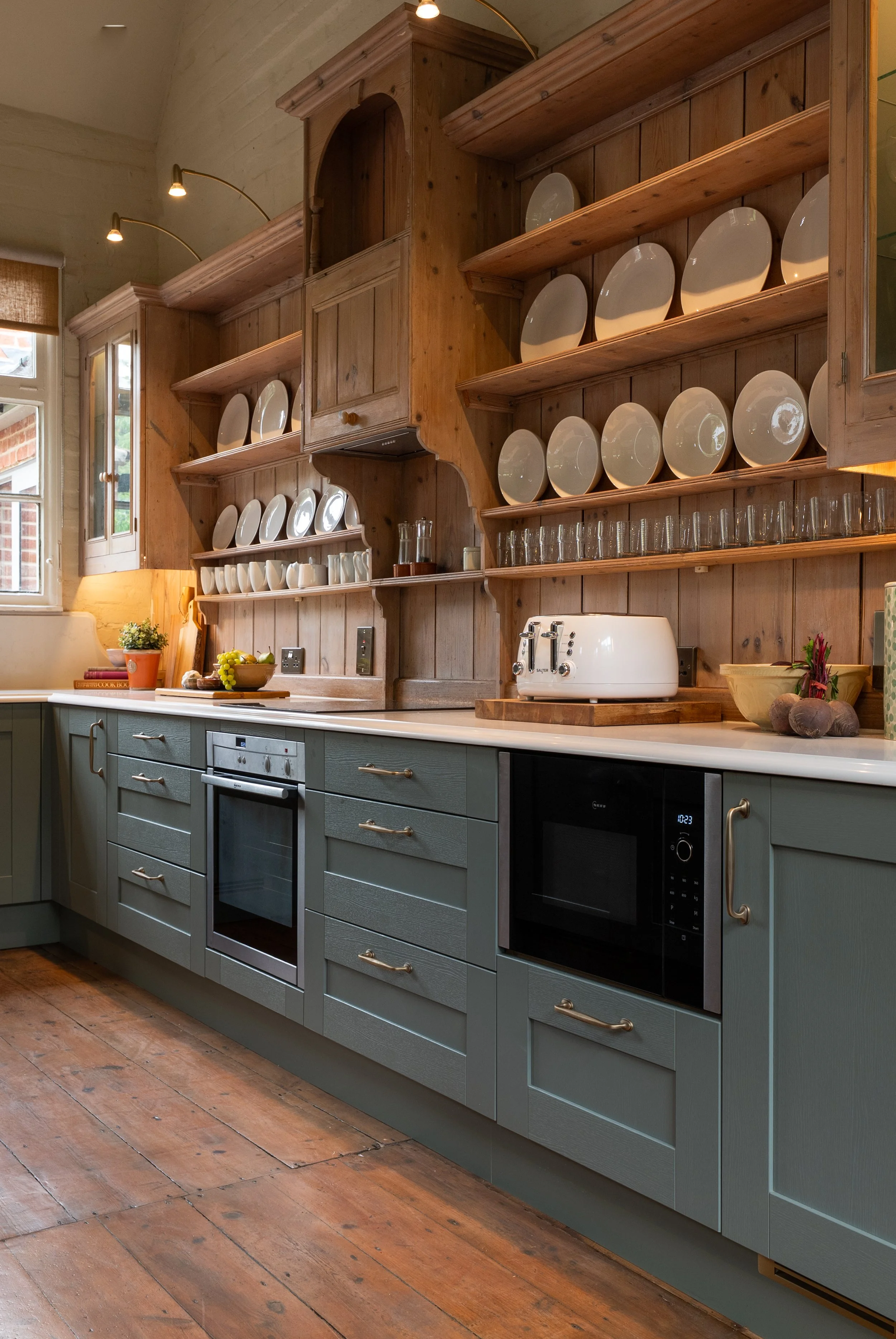 Integrated NEFF appliances within Reed Green Shaker cabinetry beneath the retained timber plate rack.