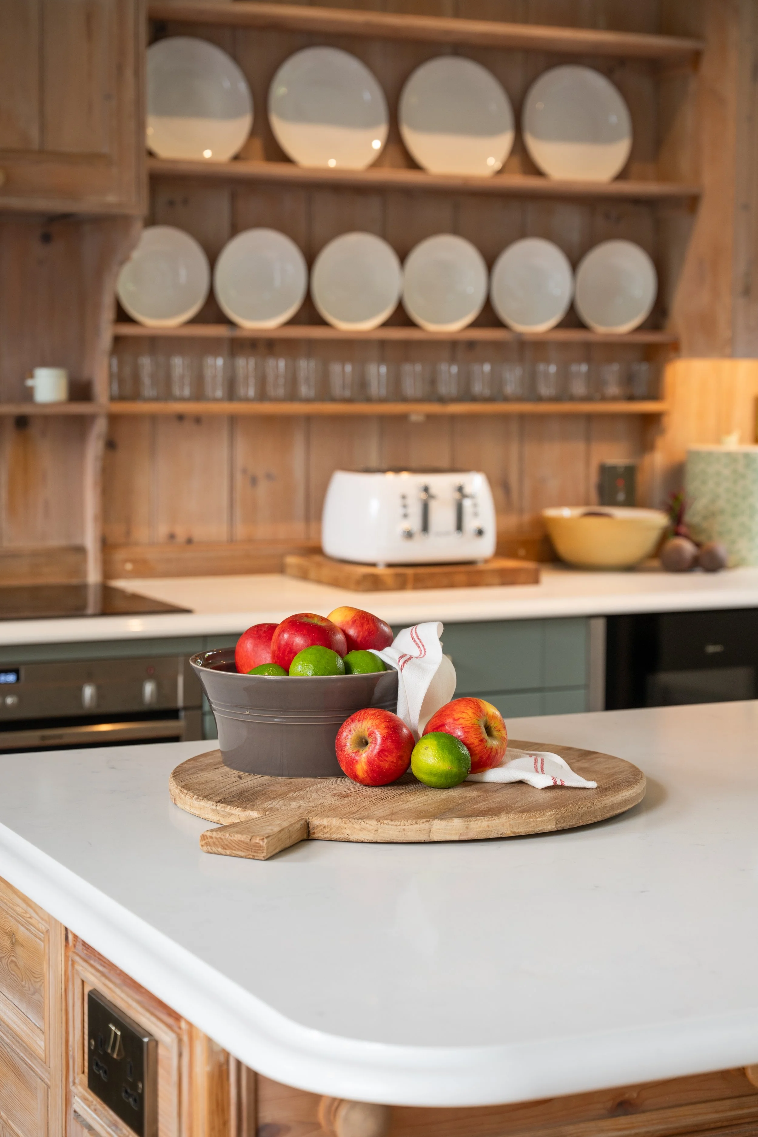 Carrara Branco quartz island with reclaimed timber cabinetry overlooking the retained plate rack in the Old School House kitchen.