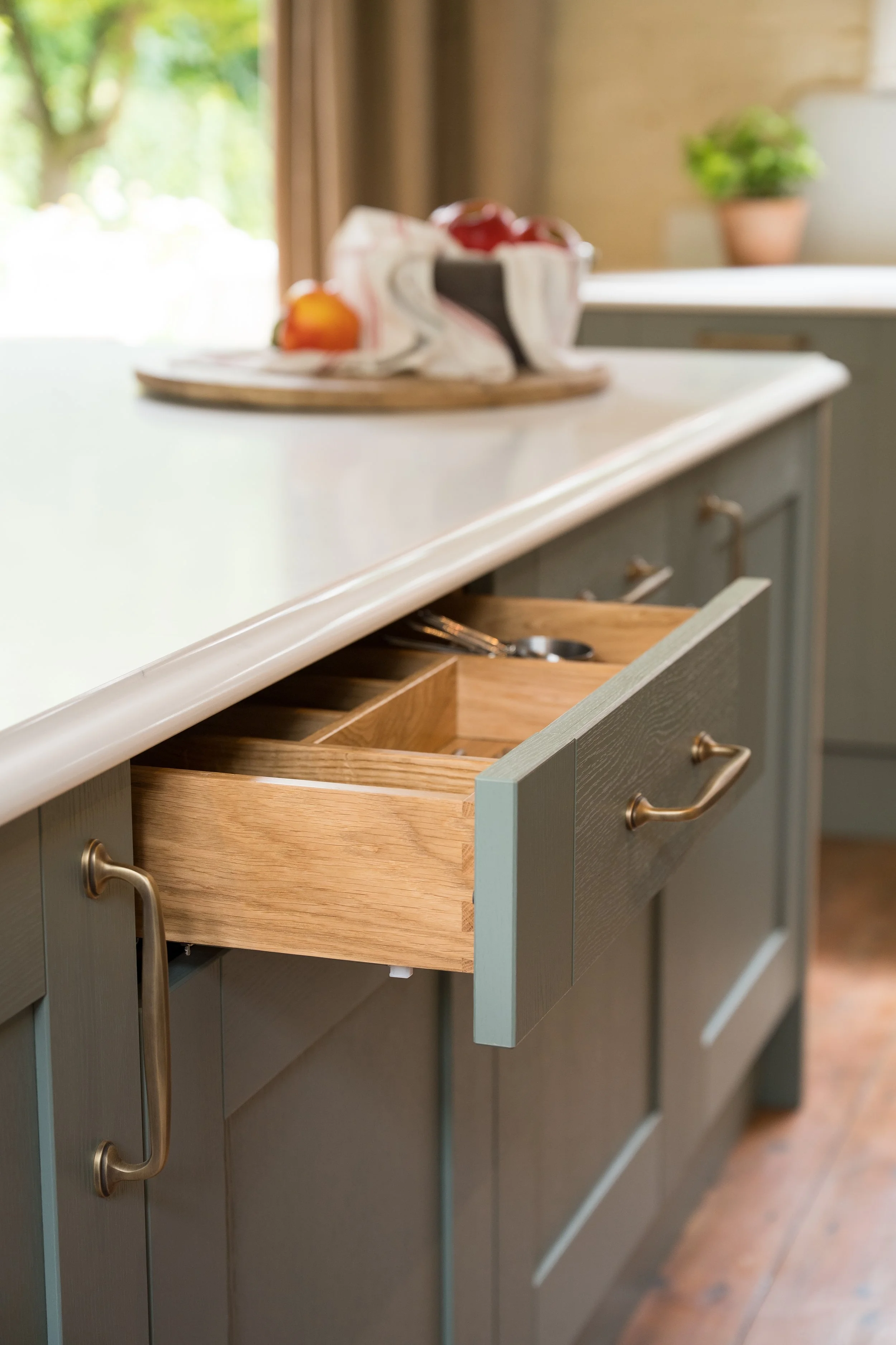 Solid oak dovetailed drawer with fitted oak cutlery insert inside the Reed Green Shaker cabinetry.