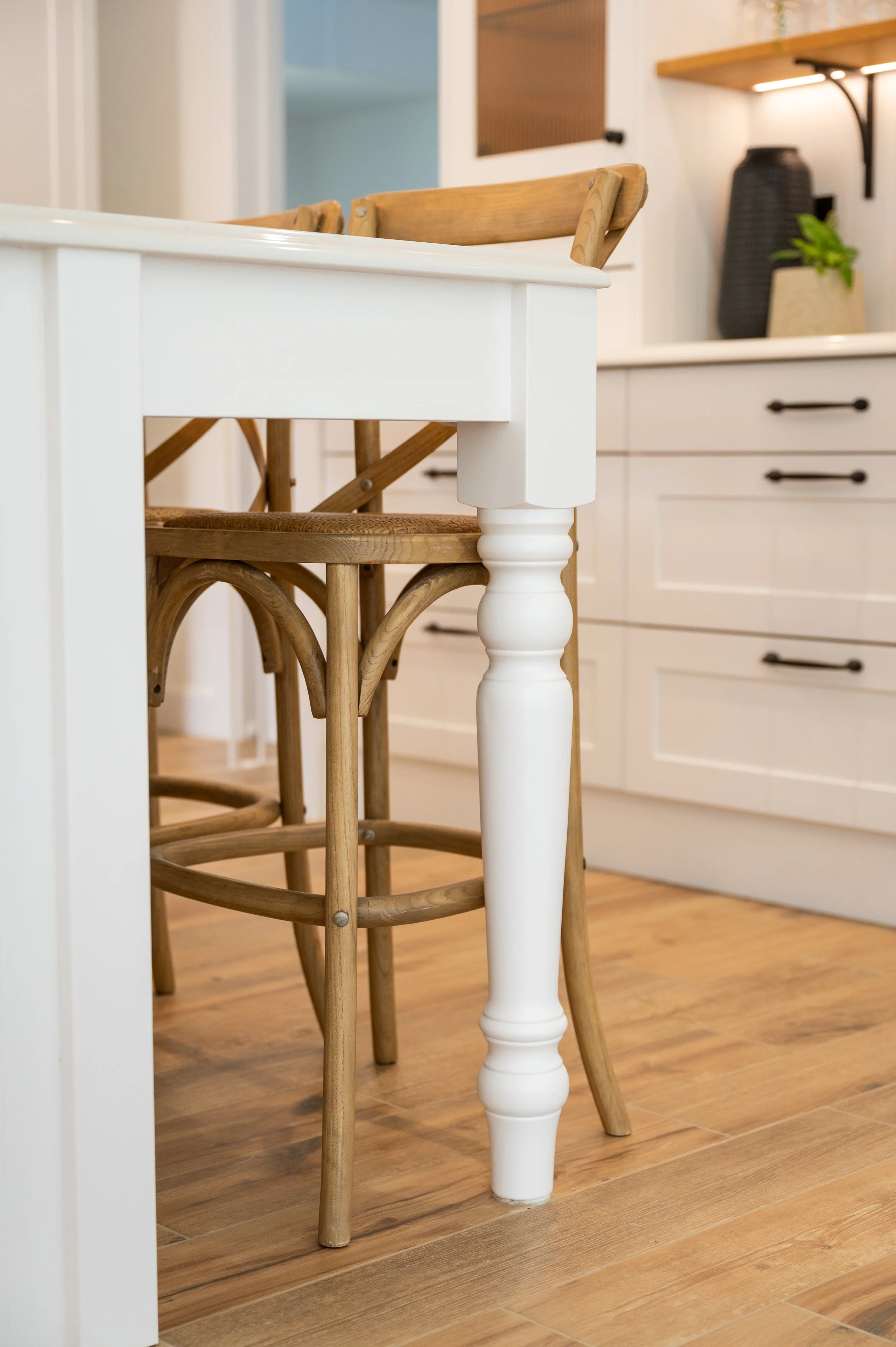 Bespoke table-style island end with painted turned leg and oak seating