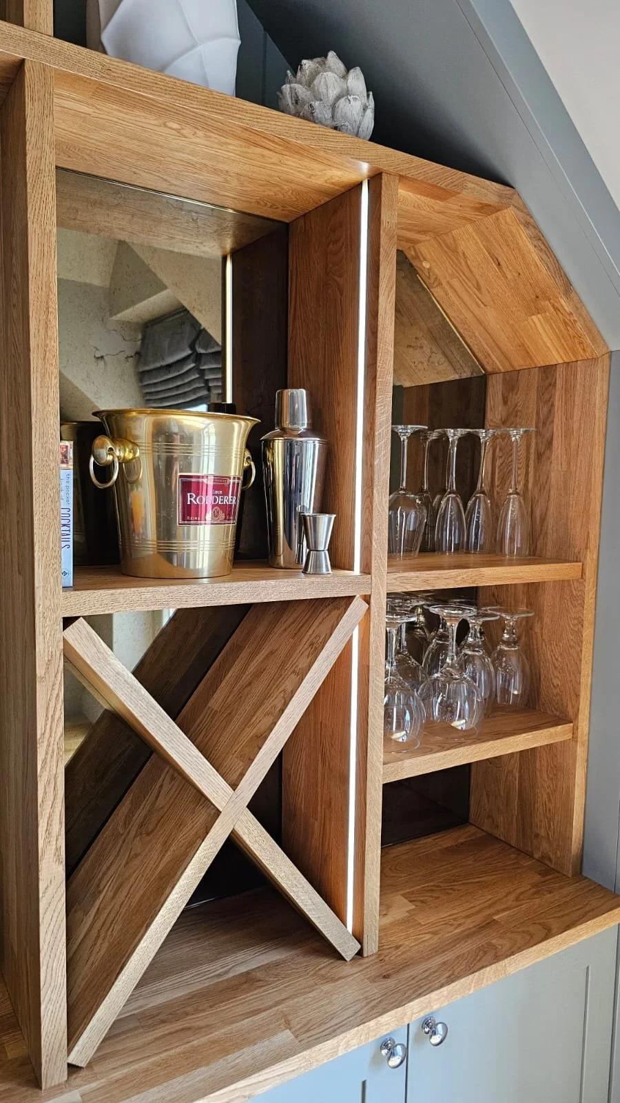Bespoke cocktail bar with antique mirror and oak shelving