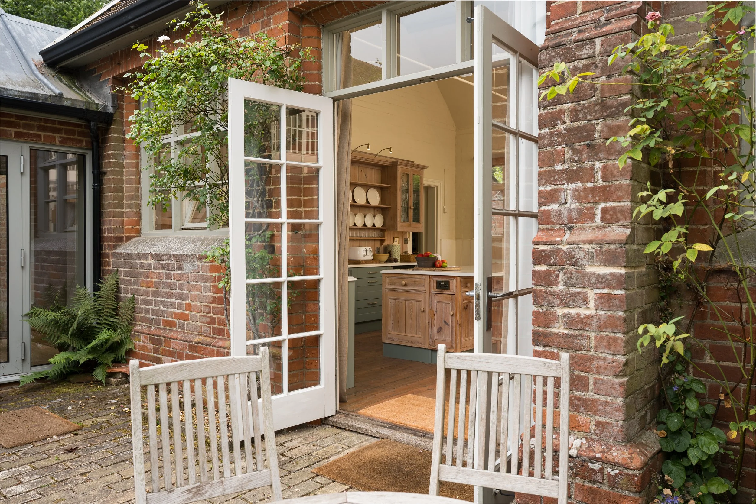 Exterior of the former Great Snoring village school with the new kitchen visible through the open doors.