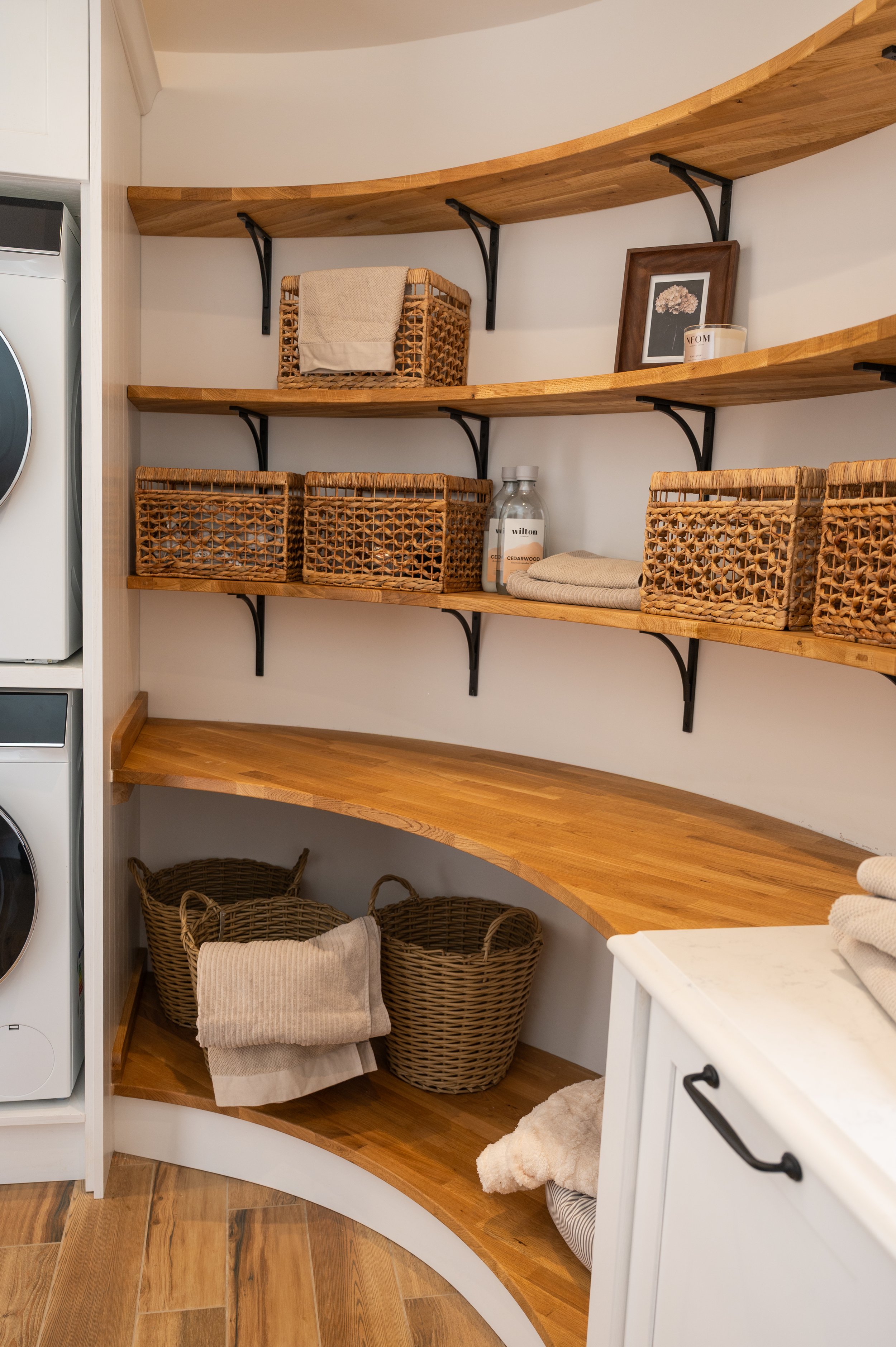 Curved solid oak shelving in the utility room, designed to follow the curved wall
