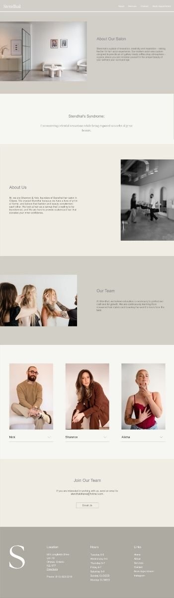 A clean and modern salon interior with white walls, framed pictures, and minimalist furniture, including a small white table and two chairs.