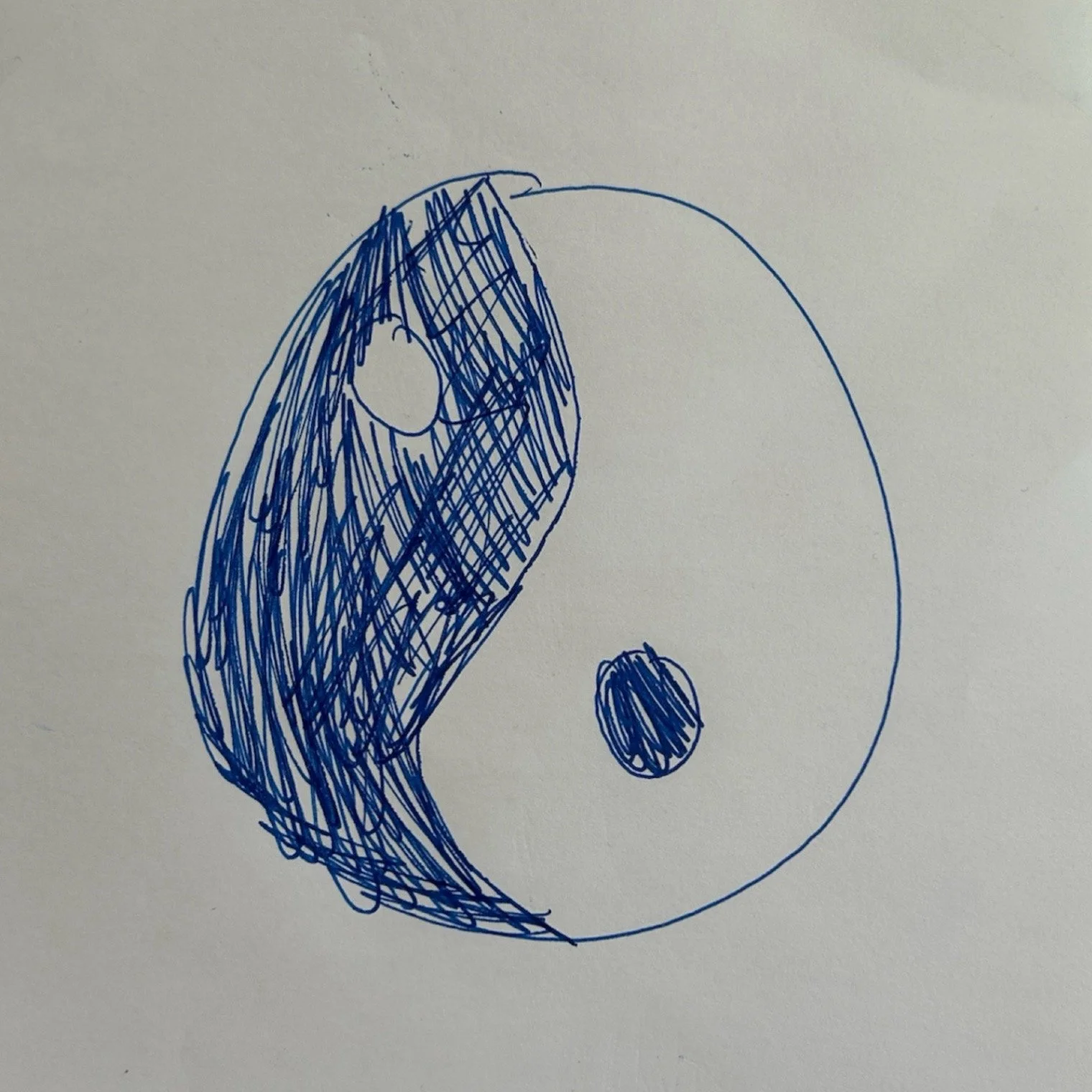 A hand-drawn illustration of a yin-yang symbol drawn in blue pen ink done by a 9 year old.