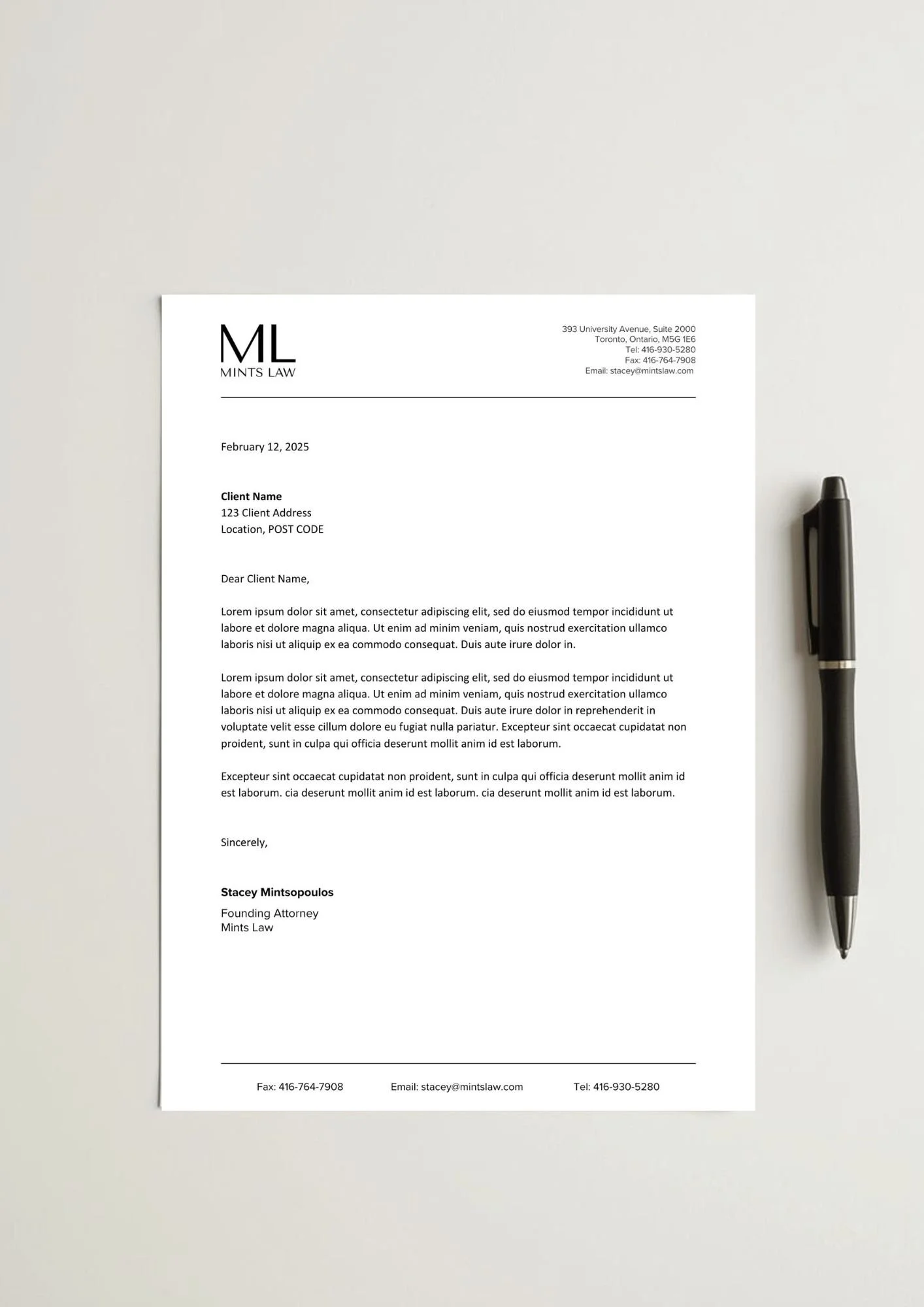 Letterhead mockup from Mints Law law firm with a black pen placed on the white sheet, on a light-colored surface.