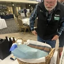Monte Billing looking over the Silent Auction Items at the 2024 MACD Convention 