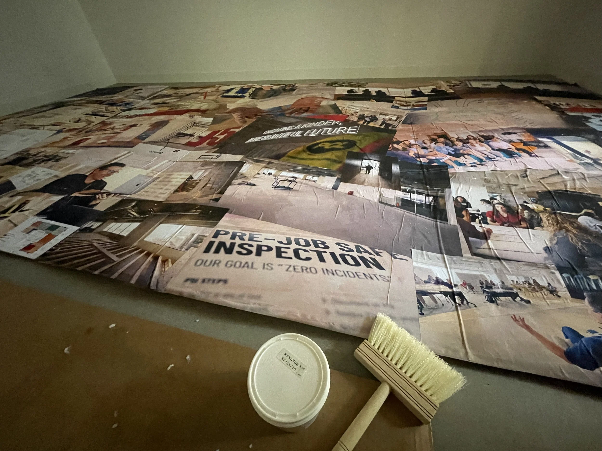 Constructing a mural for the event, using images from the build.