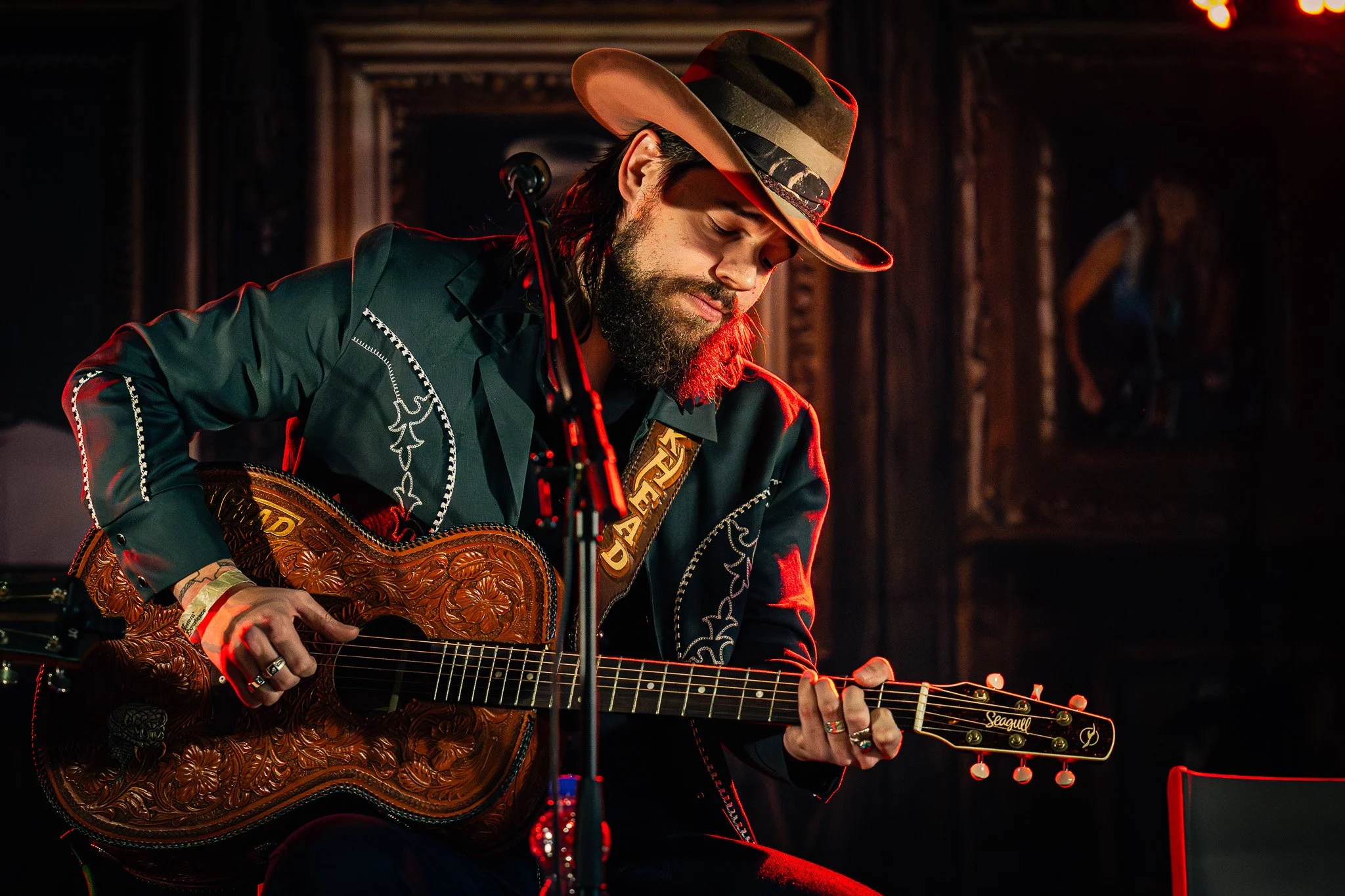 Concert photography capturing TuskHead performing live with acoustic guitar on stage