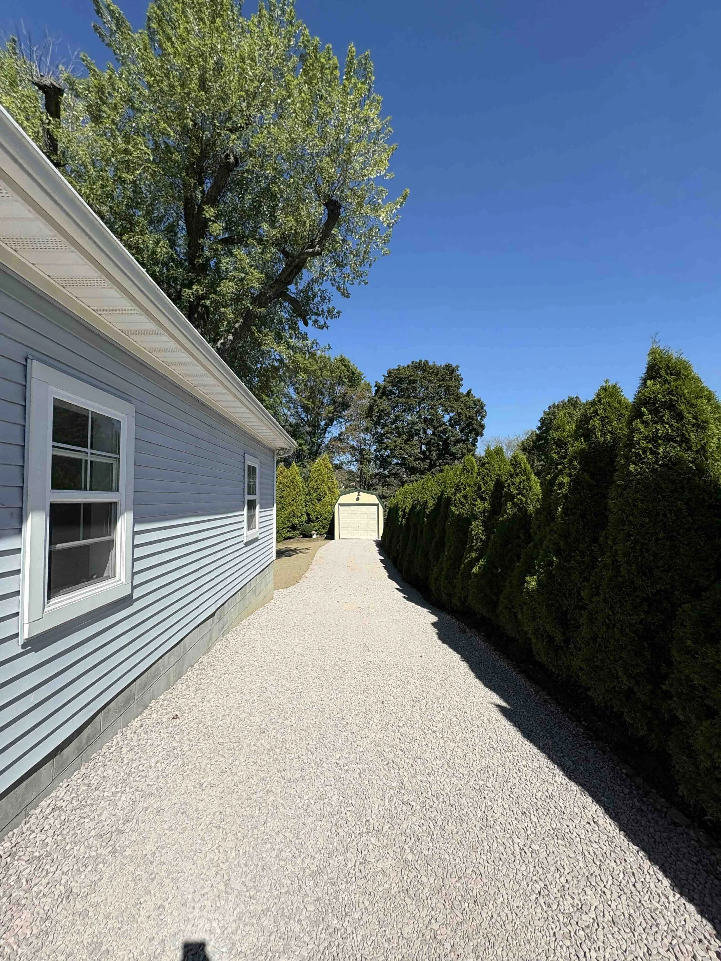 After - Fresh gravel driveway extended with proper base and weed barrier