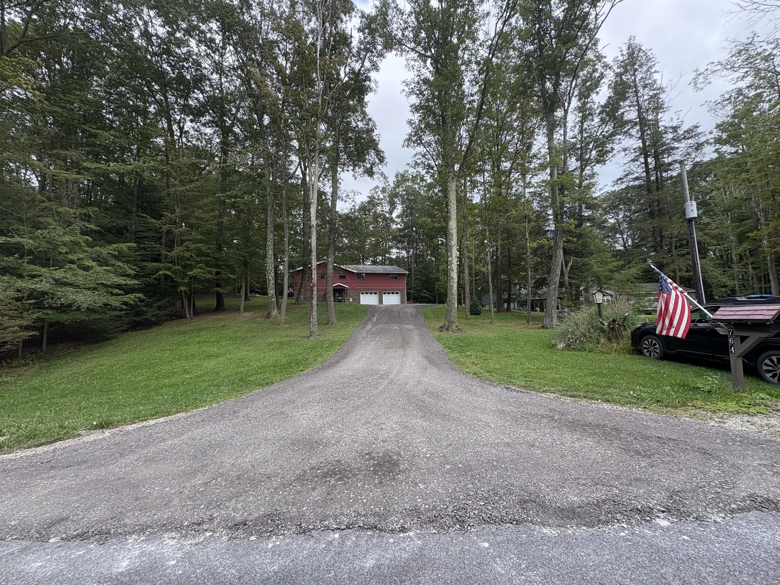 Sloped driveway with asphalt millings.