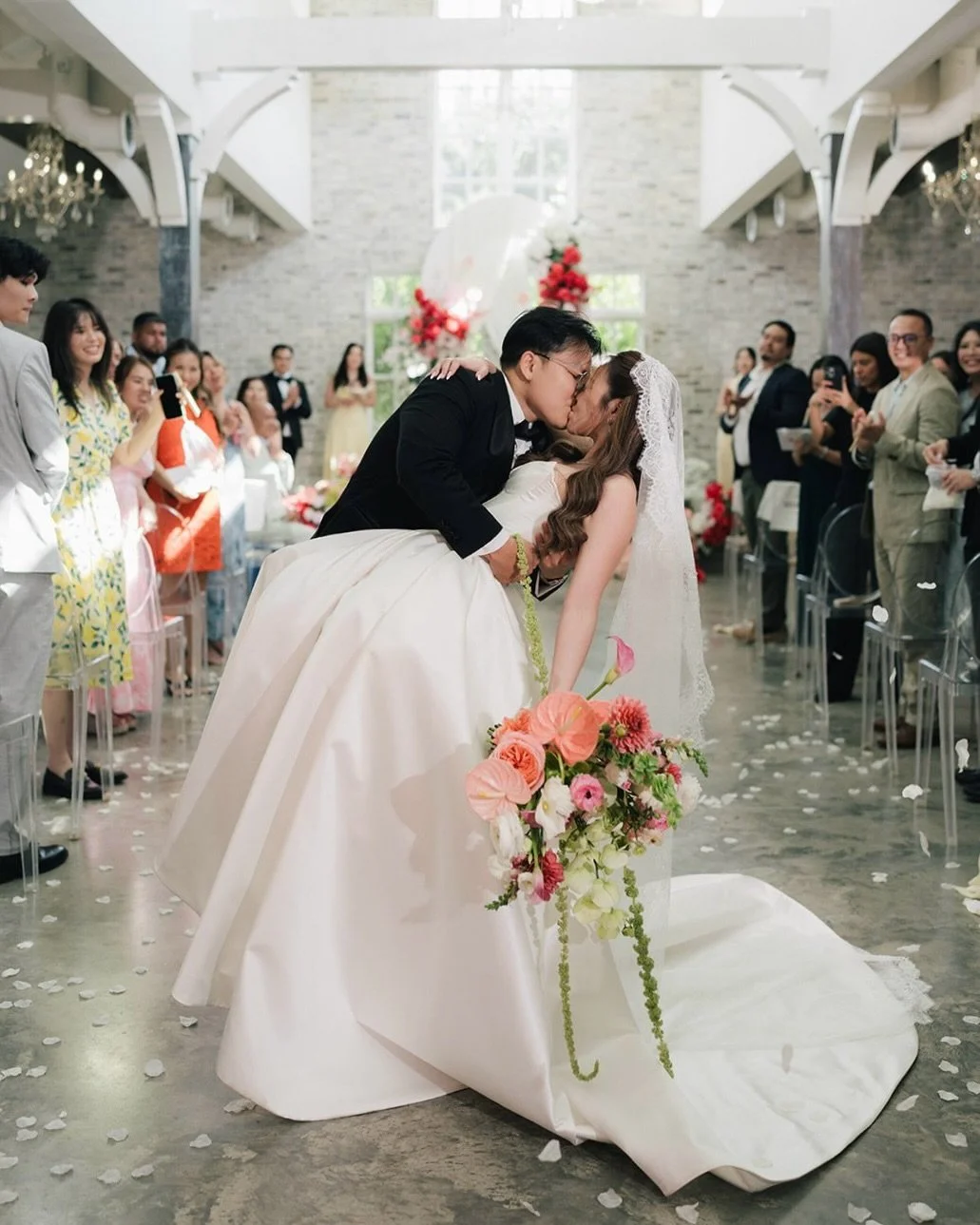 A palette that doesn&rsquo;t hold back. We brought a vibrant mix of red, pink, and hydrangea green to life across the ceremony arch, draping, and reception backdrop &mdash; proof that a romantic palette can still feel polished and modern. Congratulat