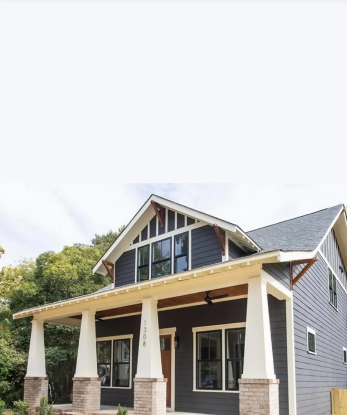 Exterior painting project showing the upper gable and covered porch.