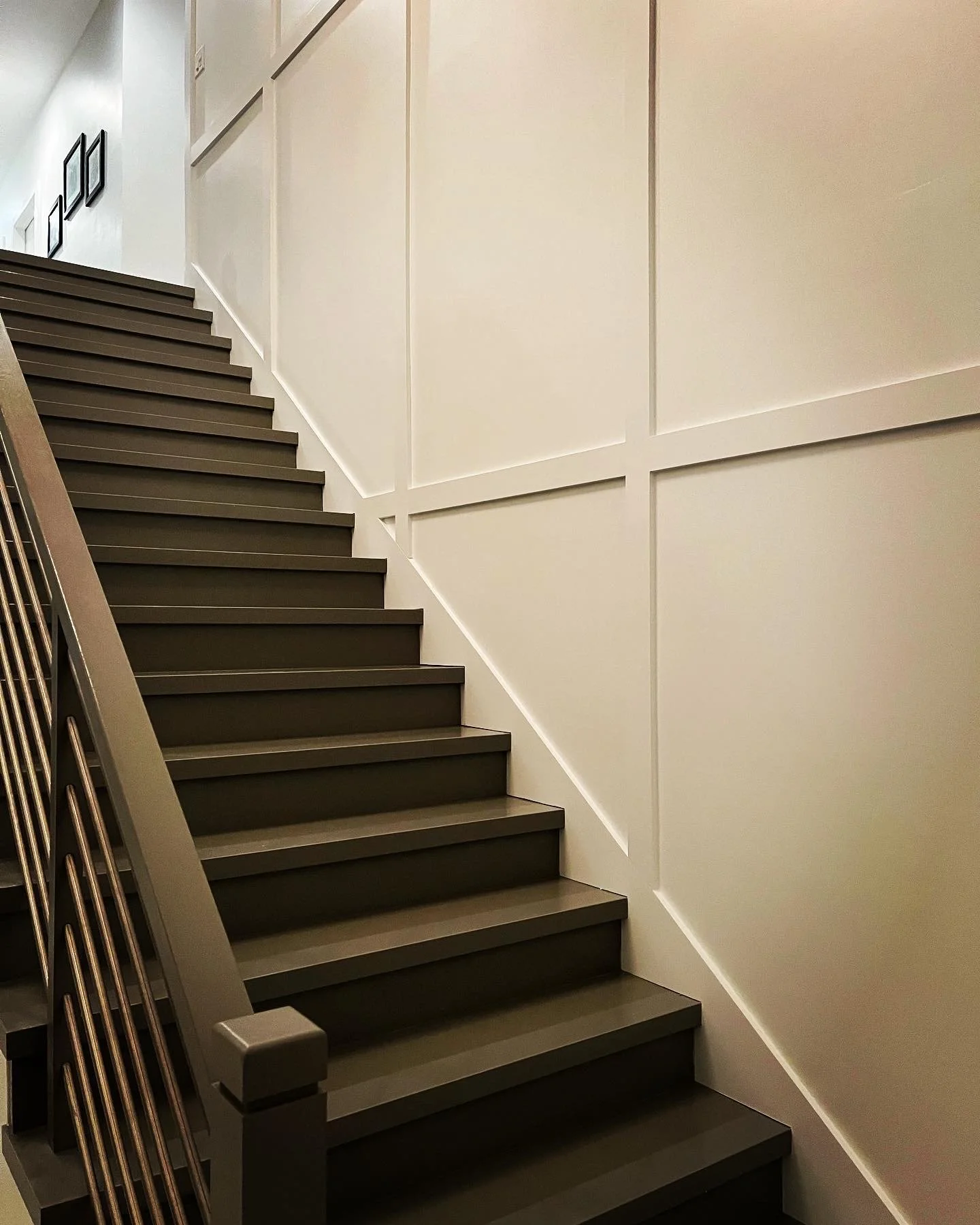 Interior stairwell with painted walls and decorative wall trim.