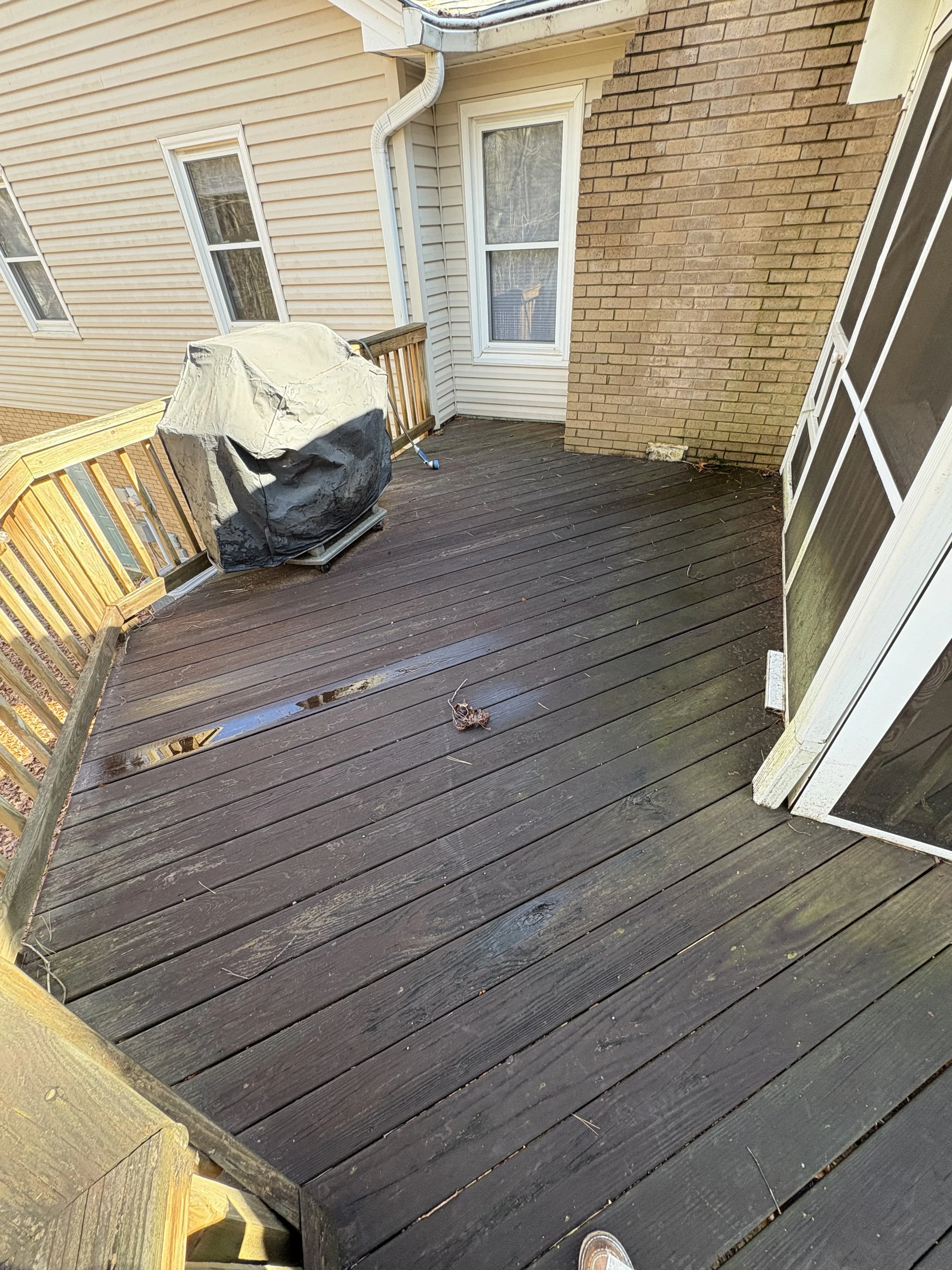 Exterior wood deck beside the home, showing the decking surface and porch entrance.