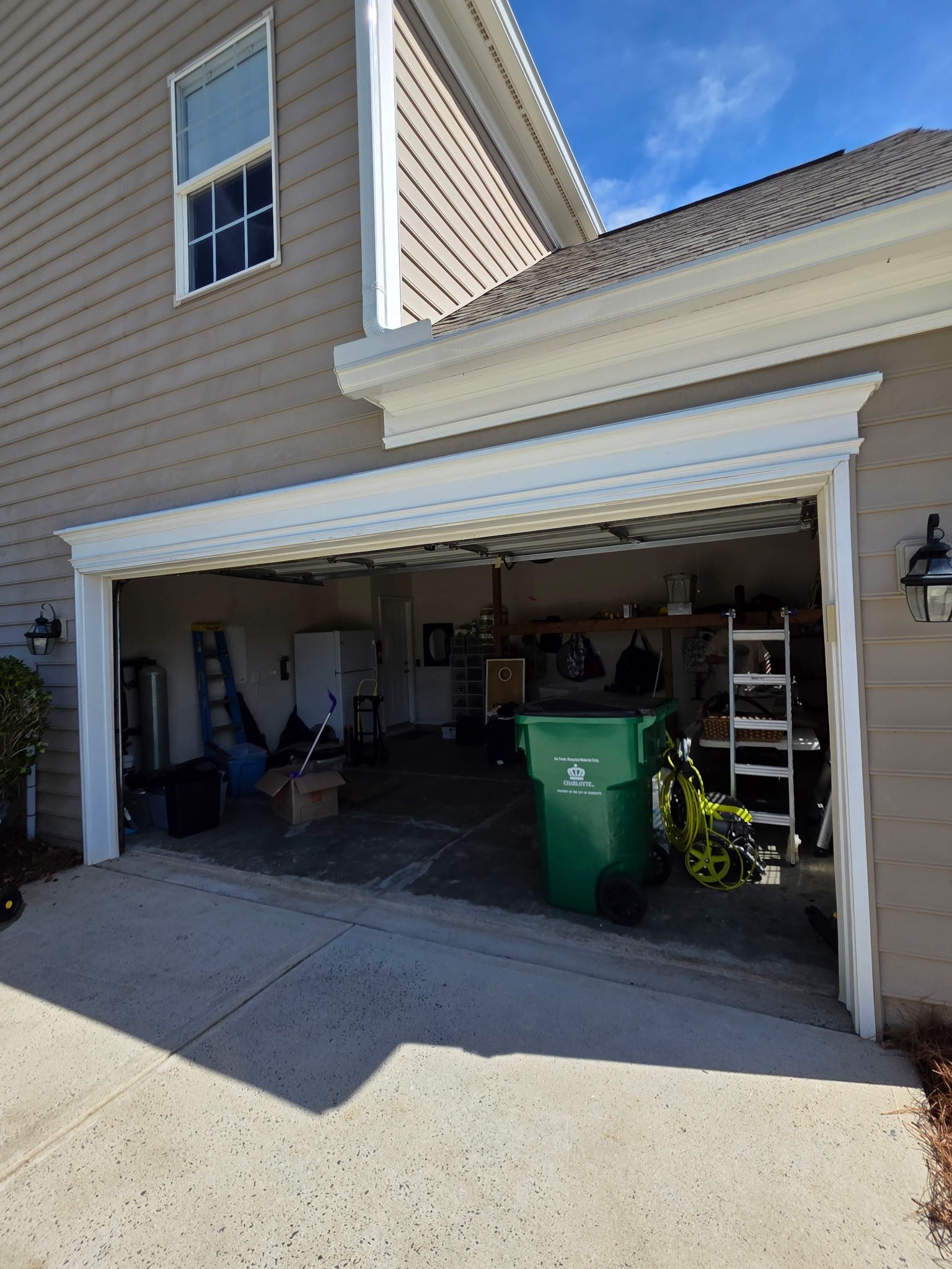 Garage-door opening after header repairs and exterior trim reinstallation, with flashing and sealing added to help manage water intrusion behind the trim.