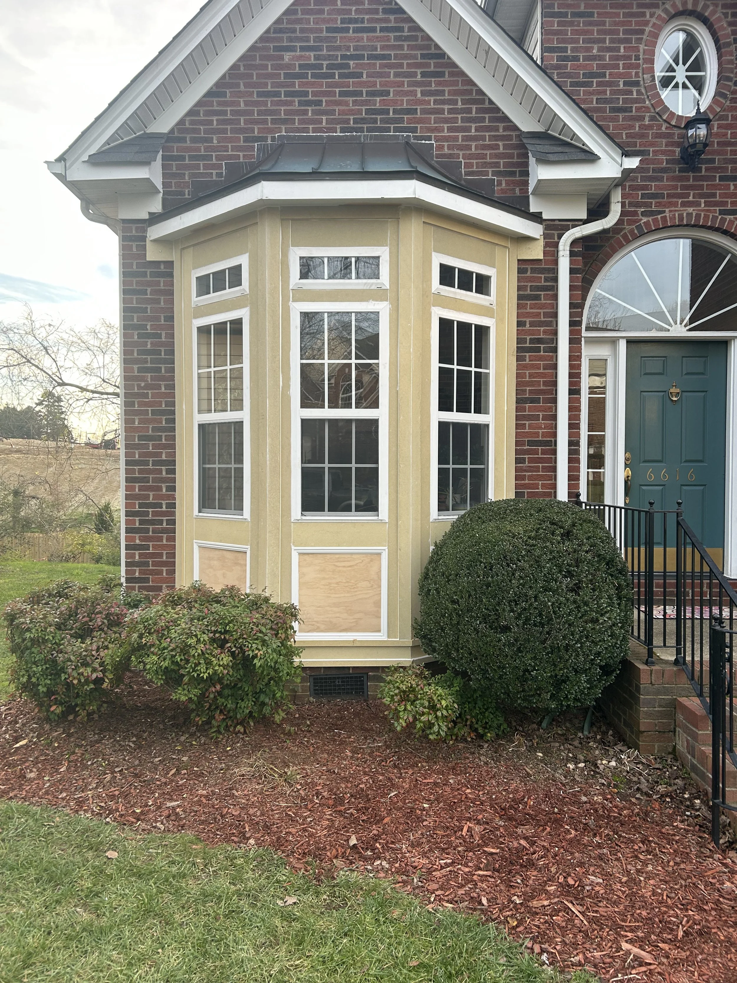 Bay-window exterior before replacement of the outdated MDF trim with new Hardie trim boards.