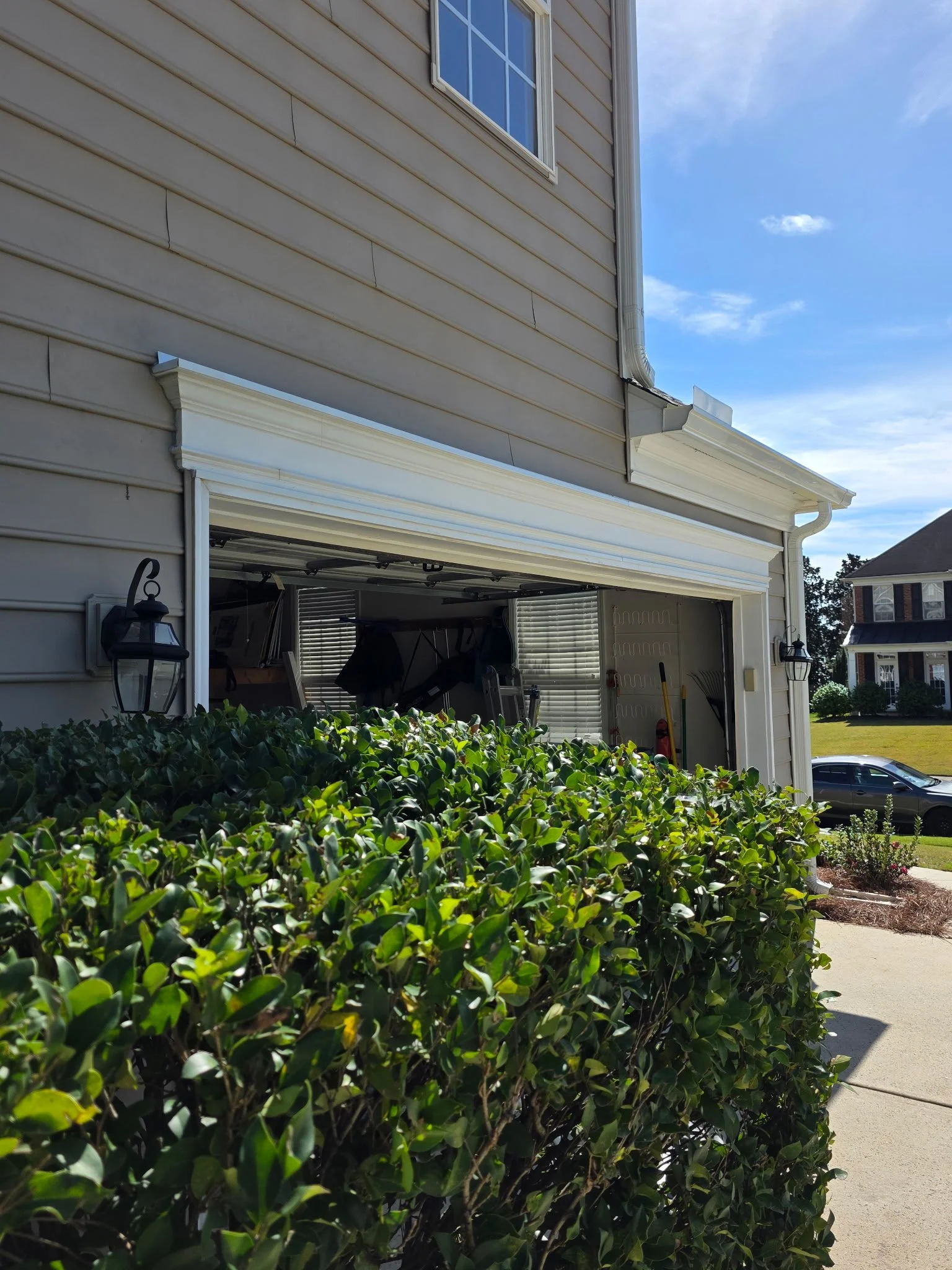Side view of the repaired garage-door opening with exterior trim back in place following header repairs, flashing installation and sealing.