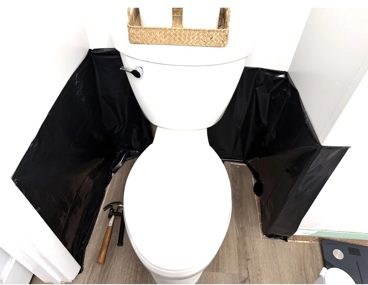 Bathroom toilet with the lid raised beside the surrounding cabinetry.