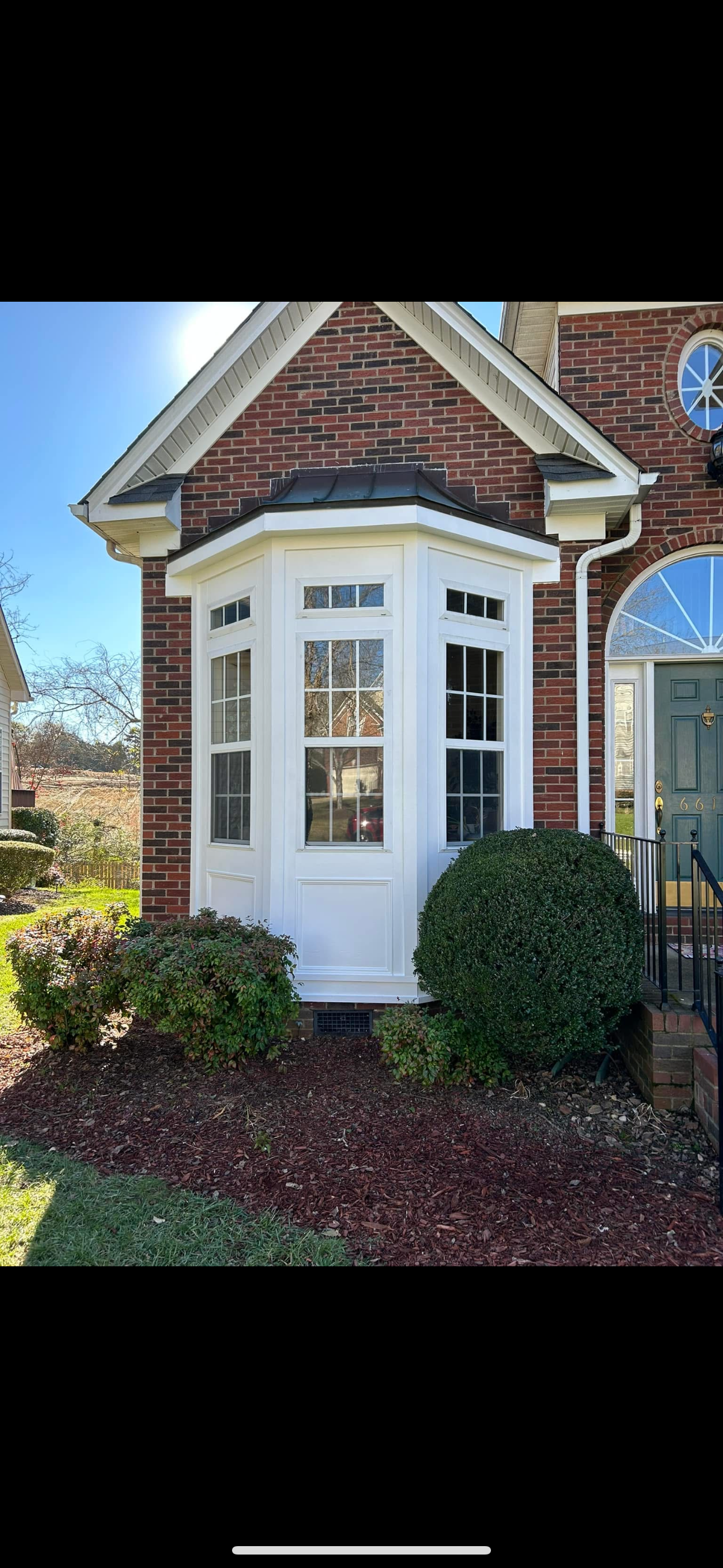 Bay-window exterior after replacement of the old MDF trim with new Hardie trim boards around the windows.
