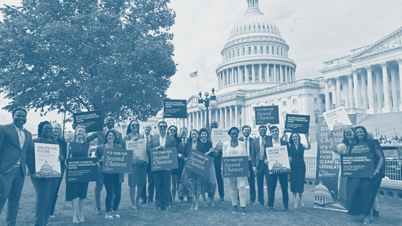 Group of advocates, including RBIJ staff, at the U.S. Capitol with the Clean Slate Initiative holding signs that say "it's time for second chances"