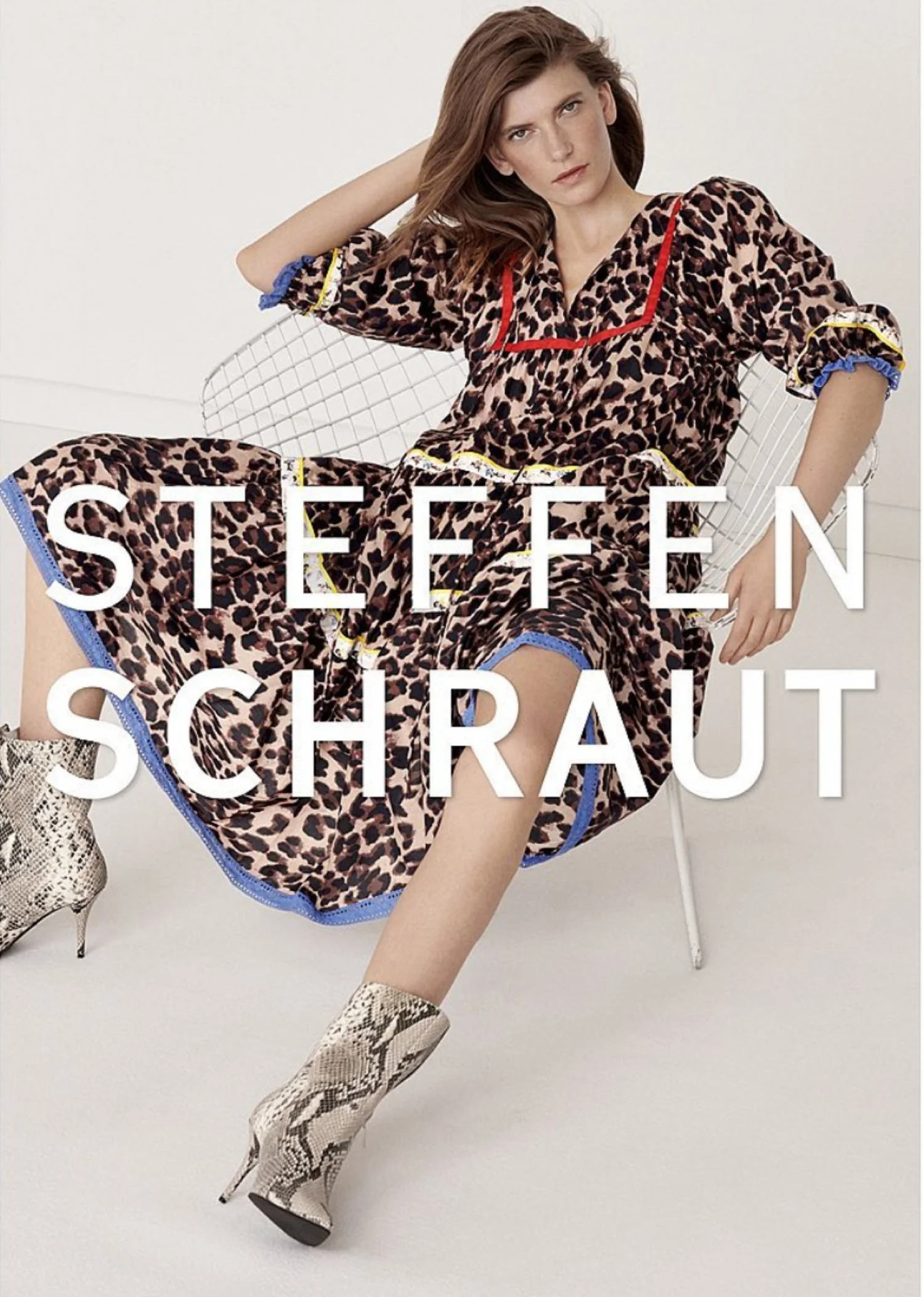 A woman dressed in a leopard print dress and snake print high heel boots, sitting on a modern chair with her arm resting on her head, with text overlay reading 'Steffen Schraut'.