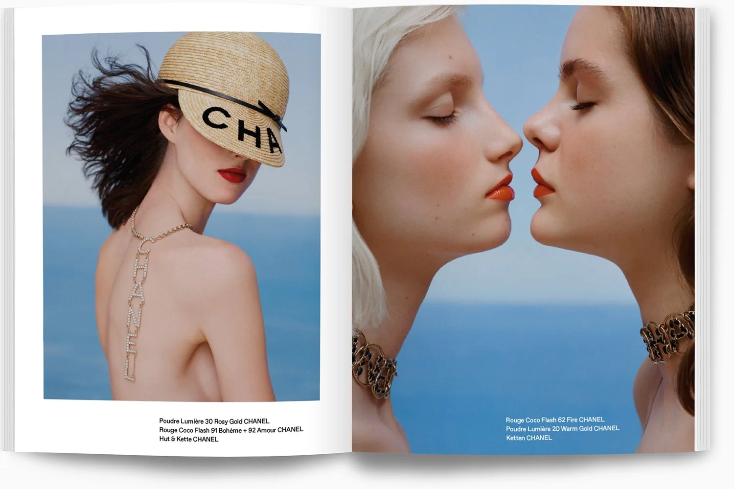 Zwei Frauen mit geschlossenen Augen, rot geschminkten Lippen, wiegen sich vor einer blauen Meereslandschaft, tragen Chanel-Schmuck und Sonnenhüte.