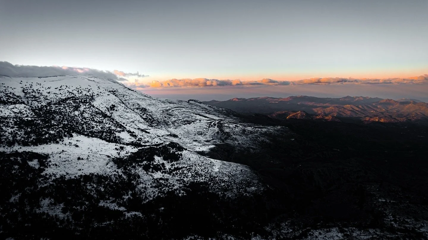 A bird&rsquo;s-eye view of Agios Nikolaos, Crete &ndash; snowy mountains in the distance. ❄️ A reminder that life is about choosing a path between darkness and light.  Which choice will you make?   #Crete #AgiosNikolaos #WinterMagic #SnowyMountains #