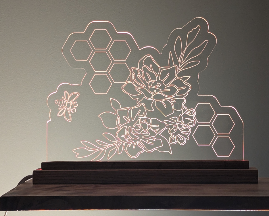 Scratch resistant acrylic etched with bee, honeycomb, and flower design. LED lights are color changing to suit your mood.