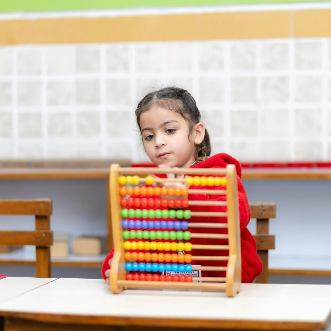 Toddler playing with counting beads