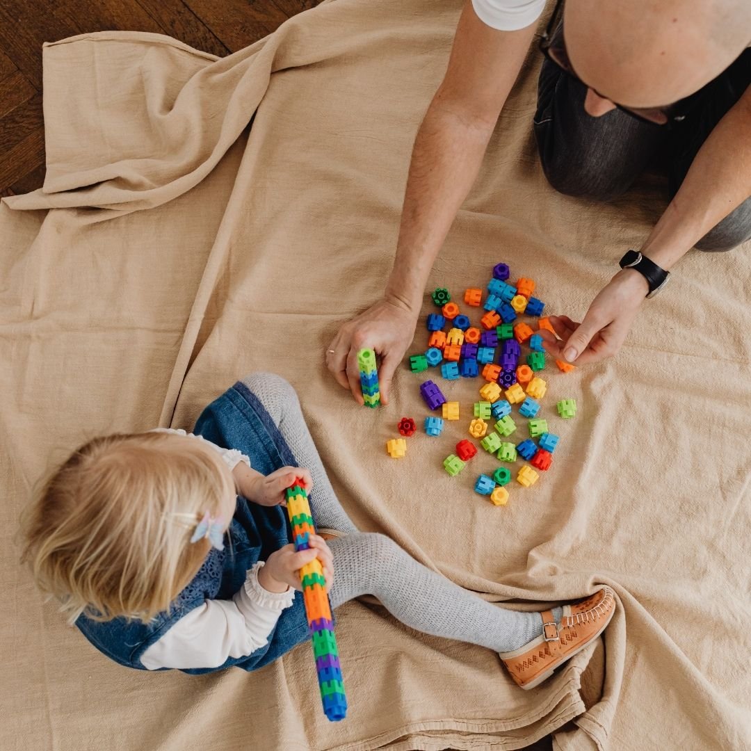 A father and infant playing.