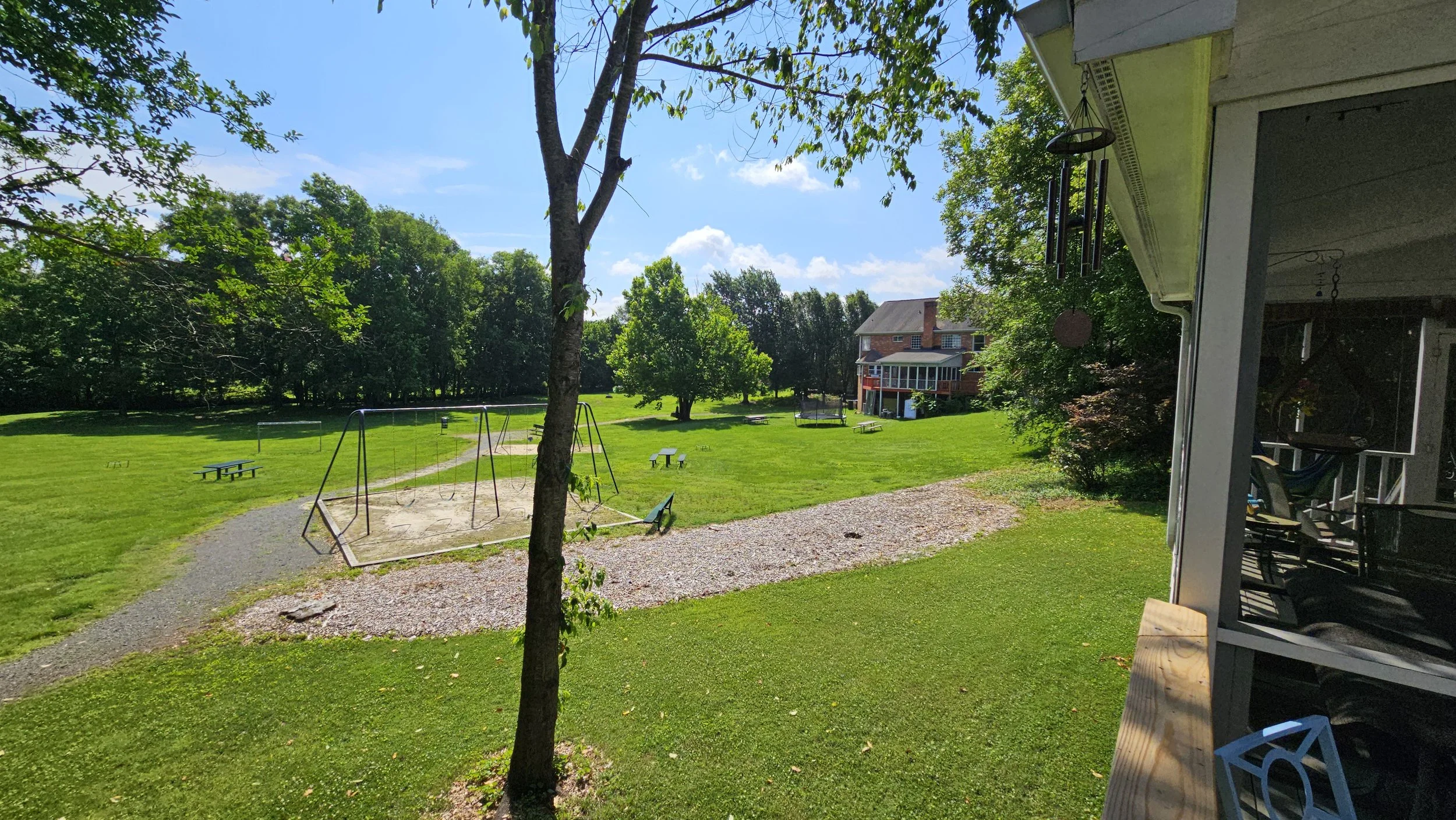 Before - backyard looking into neighborhood park and neighbors house in distance