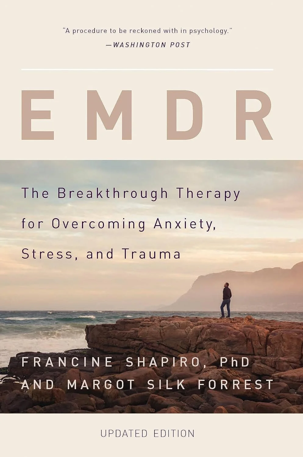 Book cover titled 'EMDR: The Breakthrough Therapy for Overcoming Anxiety, Stress, and Trauma' by Francine Shapiro PhD and Margot Silk Forrest, featuring a person standing on rocks by the ocean at sunset.