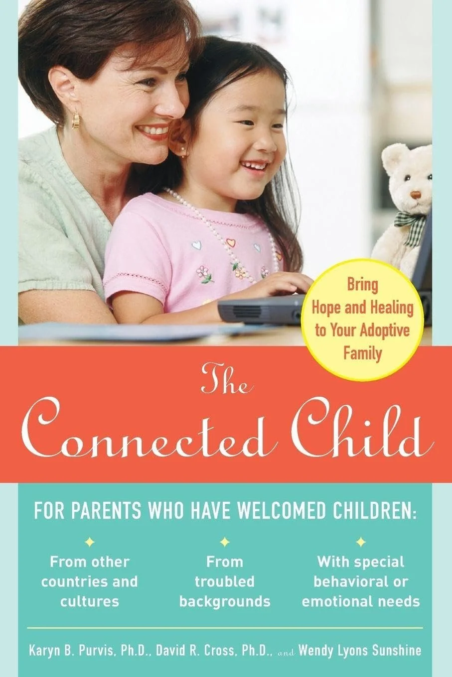 Book cover titled "The Connected Child" showing an adult and a child smiling at a laptop with a teddy bear beside them.