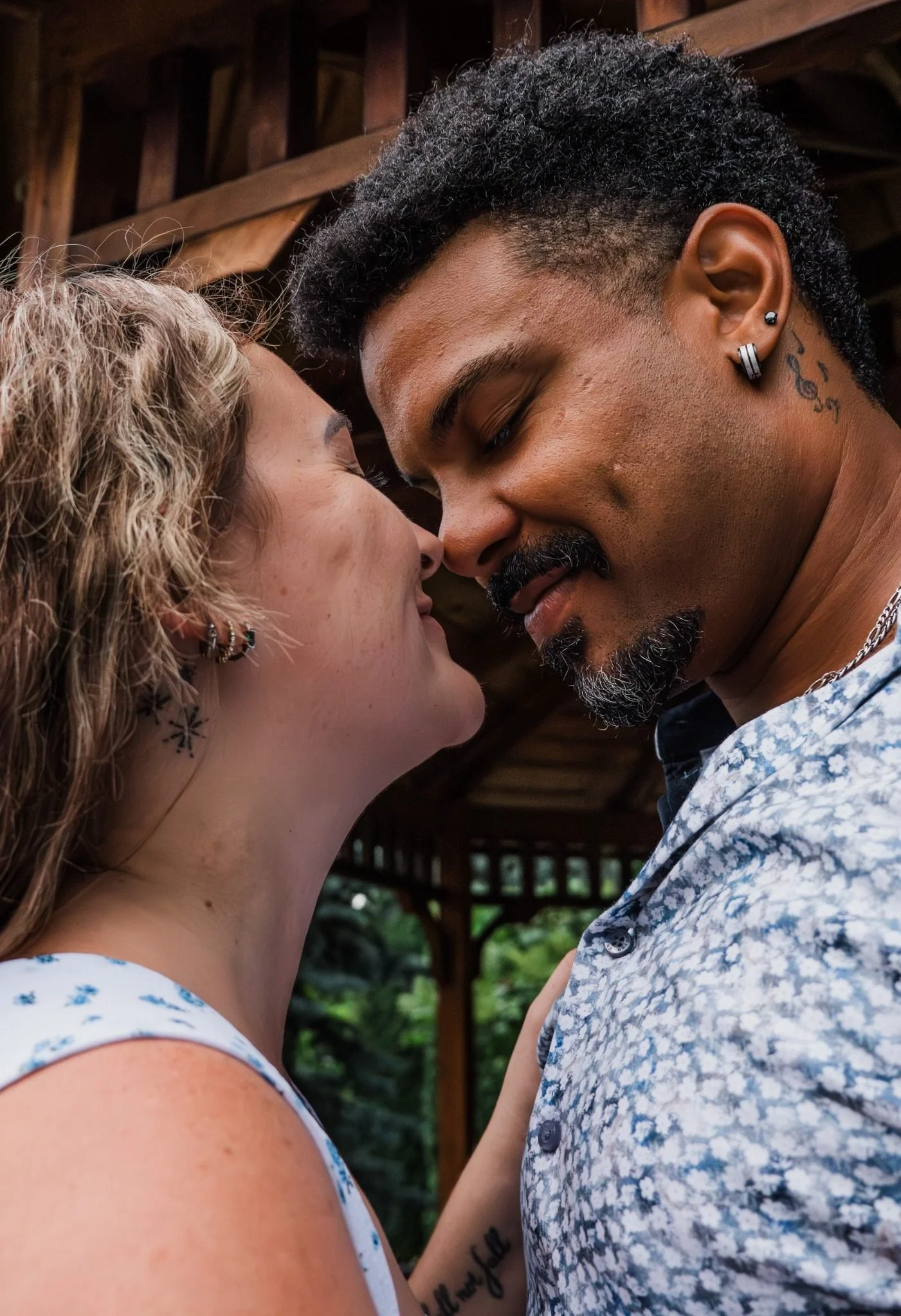 Engaged couple sharing a quiet close-up moment at St. Albert Botanic Park, photographed by Kevin M Films.