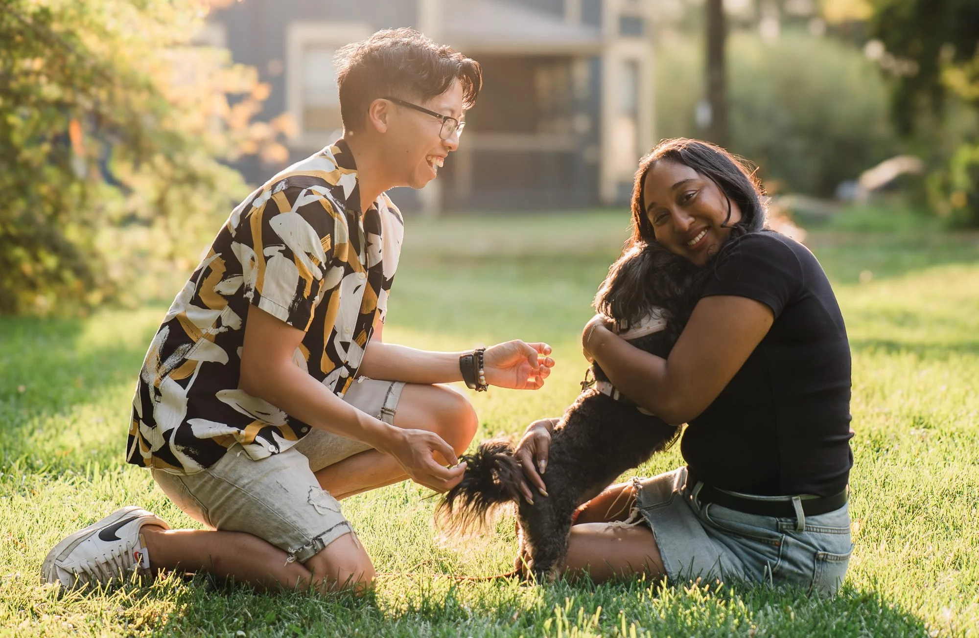 Couple sitting with their dog in warm evening light during an Edmonton couples photography session by Kevin M Films.