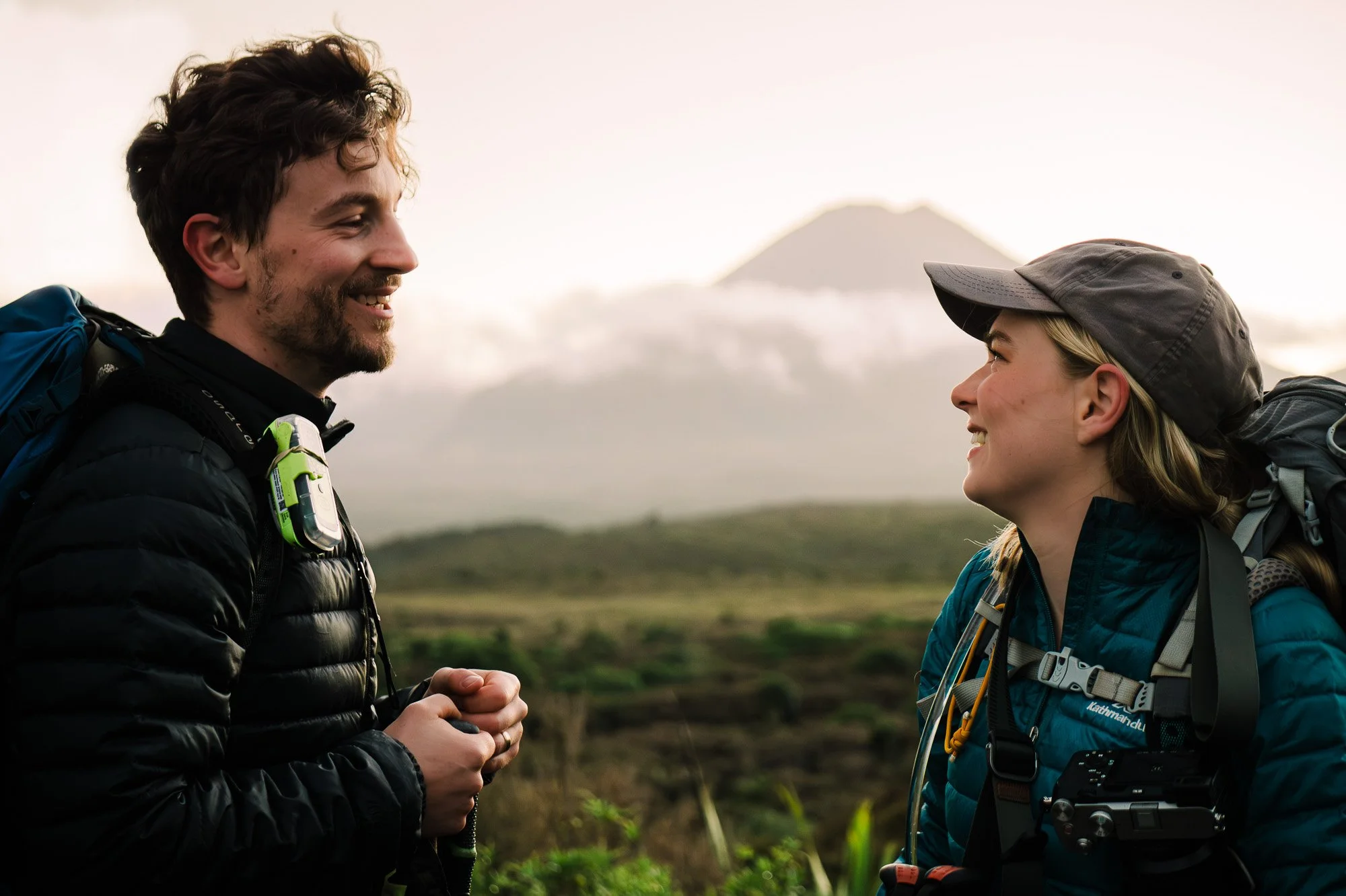 Couple smiling together on Mounds Walk in Tongariro National Park during a New Zealand couples photography session by Kevin M Films.