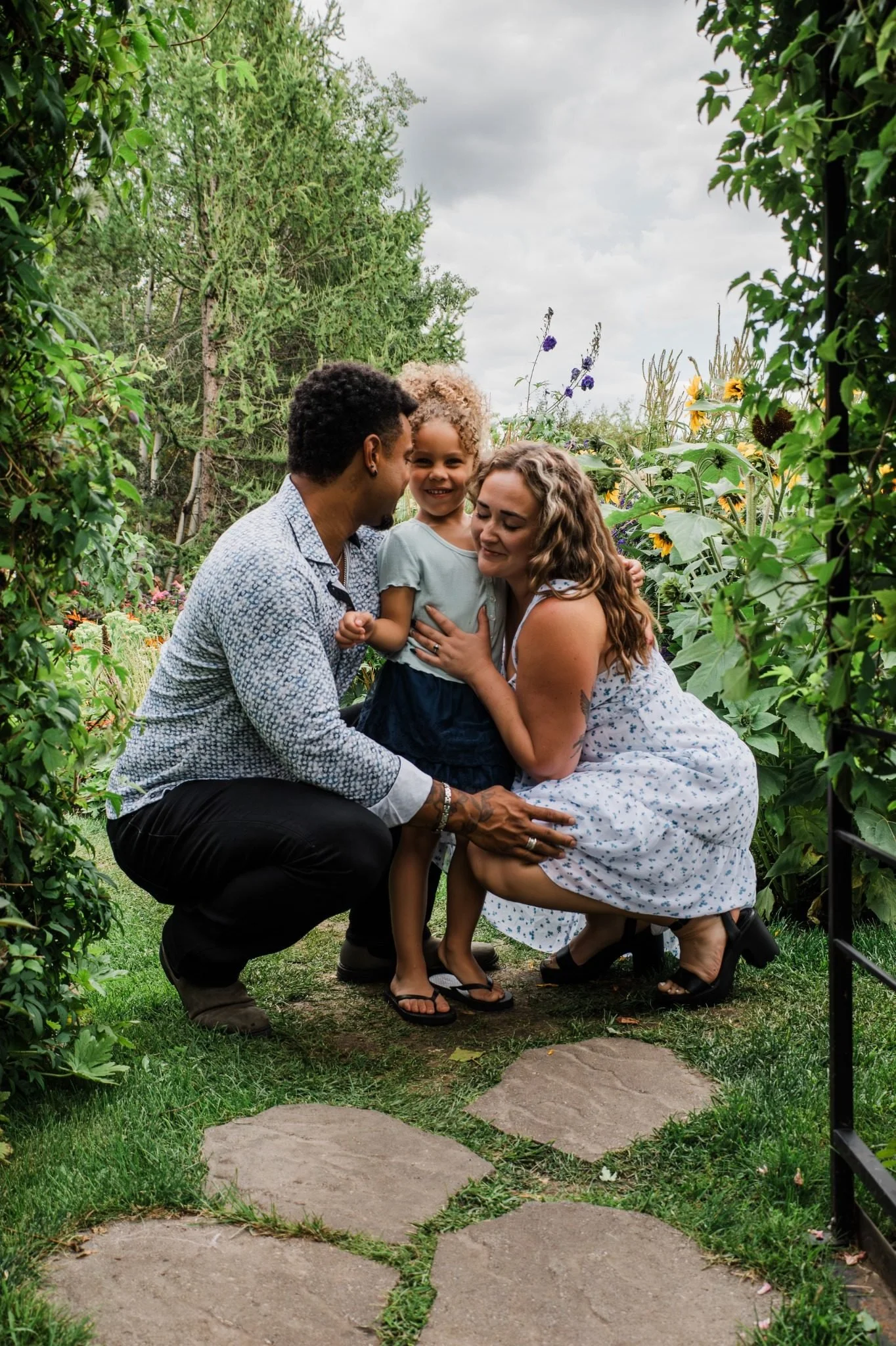 Family posing together at St. Albert Botanic Park during an Edmonton family photography session by Kevin M Films.