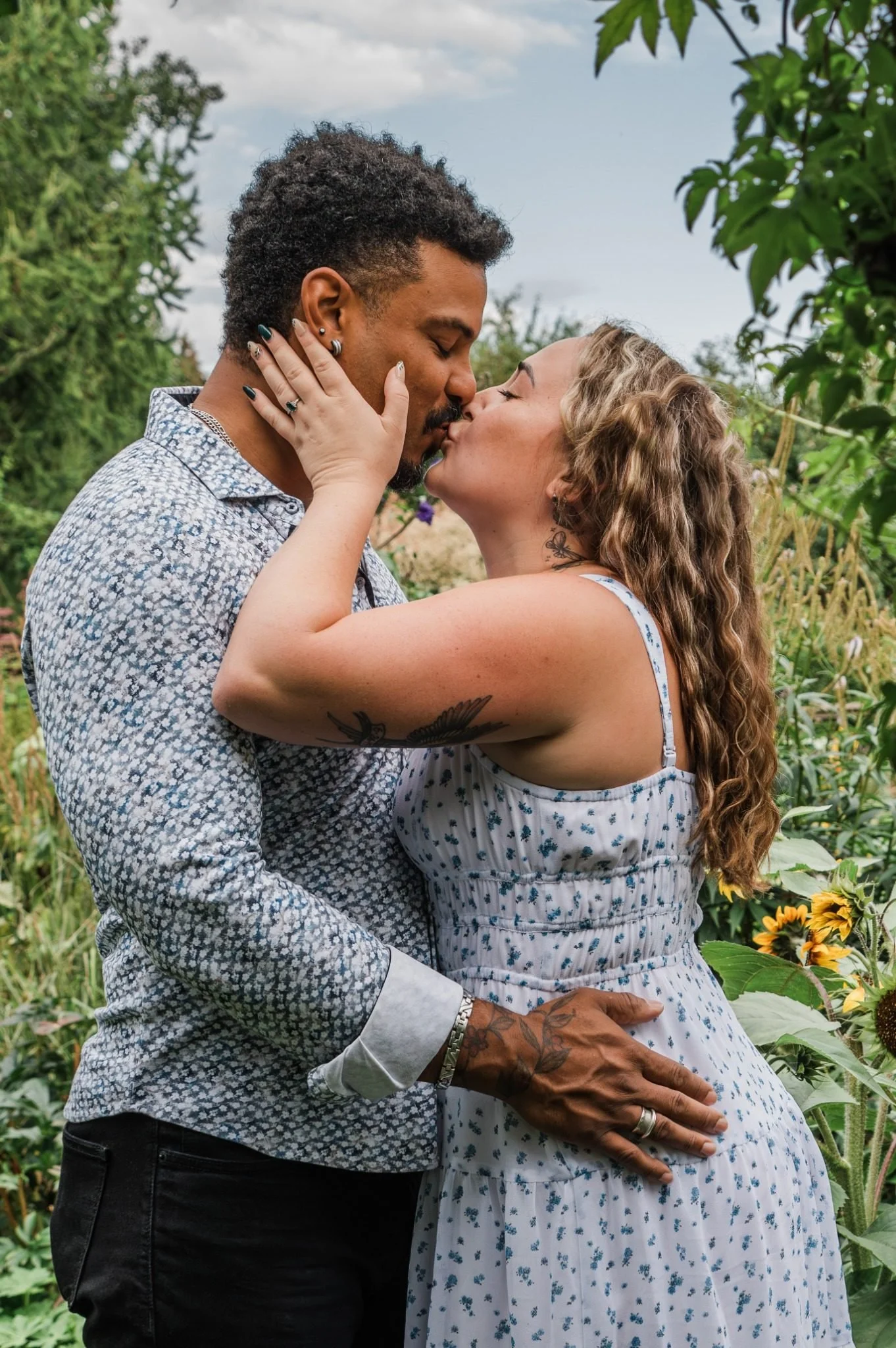Couple kissing at the St. Albert Botanic Park during an Edmonton engagement photography session by Kevin M Films.