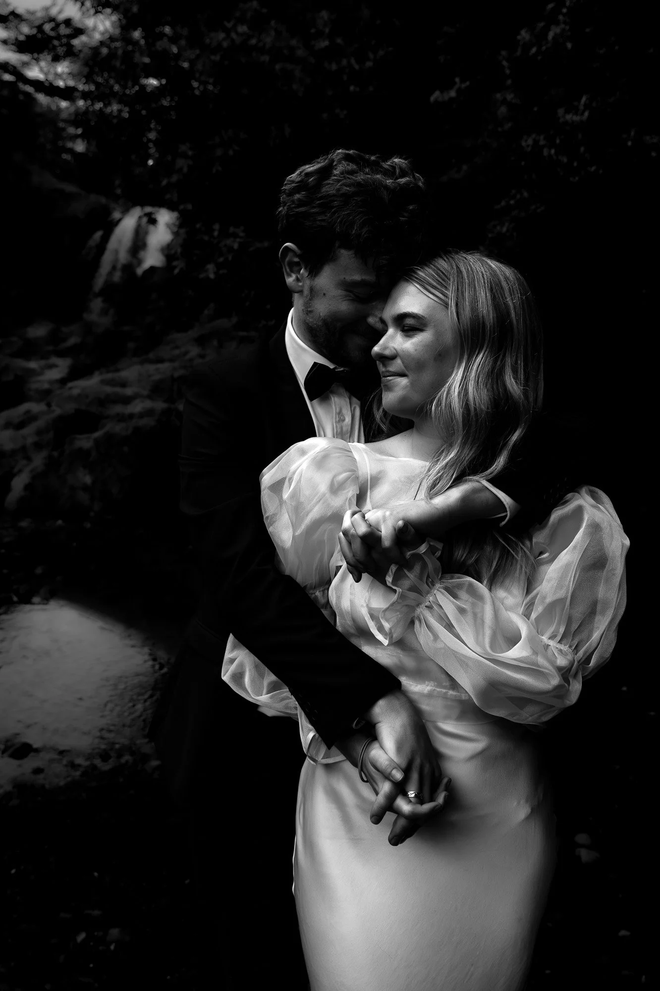 Black-and-white styled elopement portrait near Tawhai Falls during a New Zealand elopement photography session by Kevin M Films.