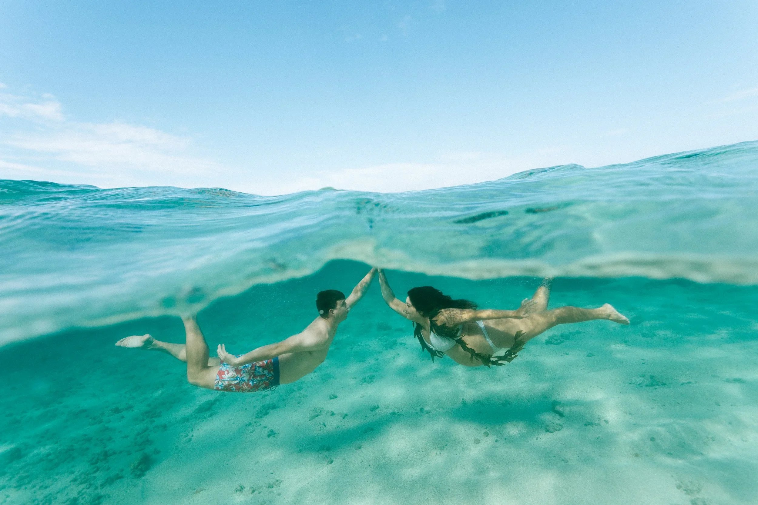 Oahu Babymoon Photographer couple underwater maternity photoshoot in Hawaii