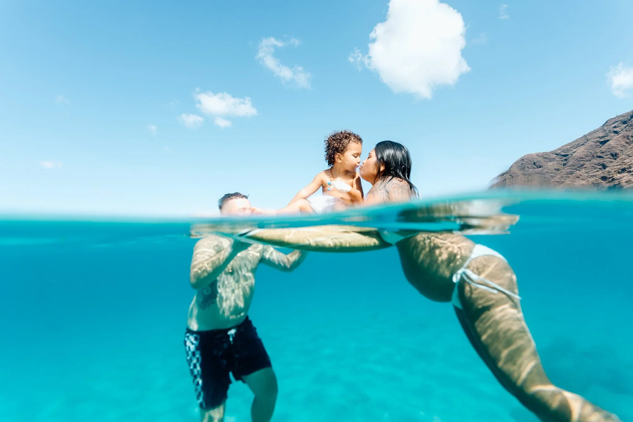 Hawaii Babymoon Photographer specializing in underwater maternity photoshoots for your family
