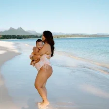 Woman with toddler smiling during hawaii maternity photoshoot on oahu