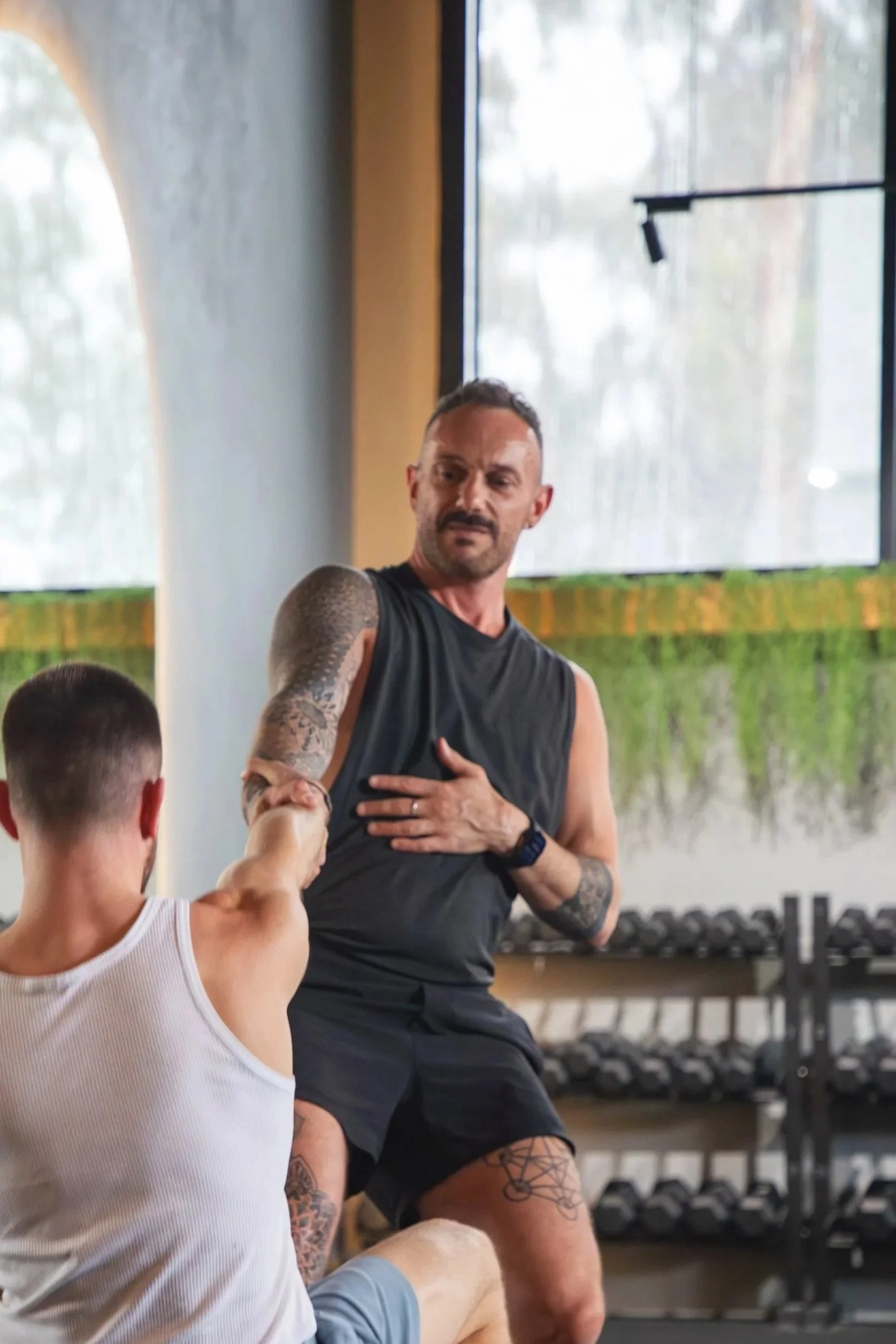 Justin demonstrating how to support your partner in an Acro Yoga workshop at Flow St8 in Melbourne