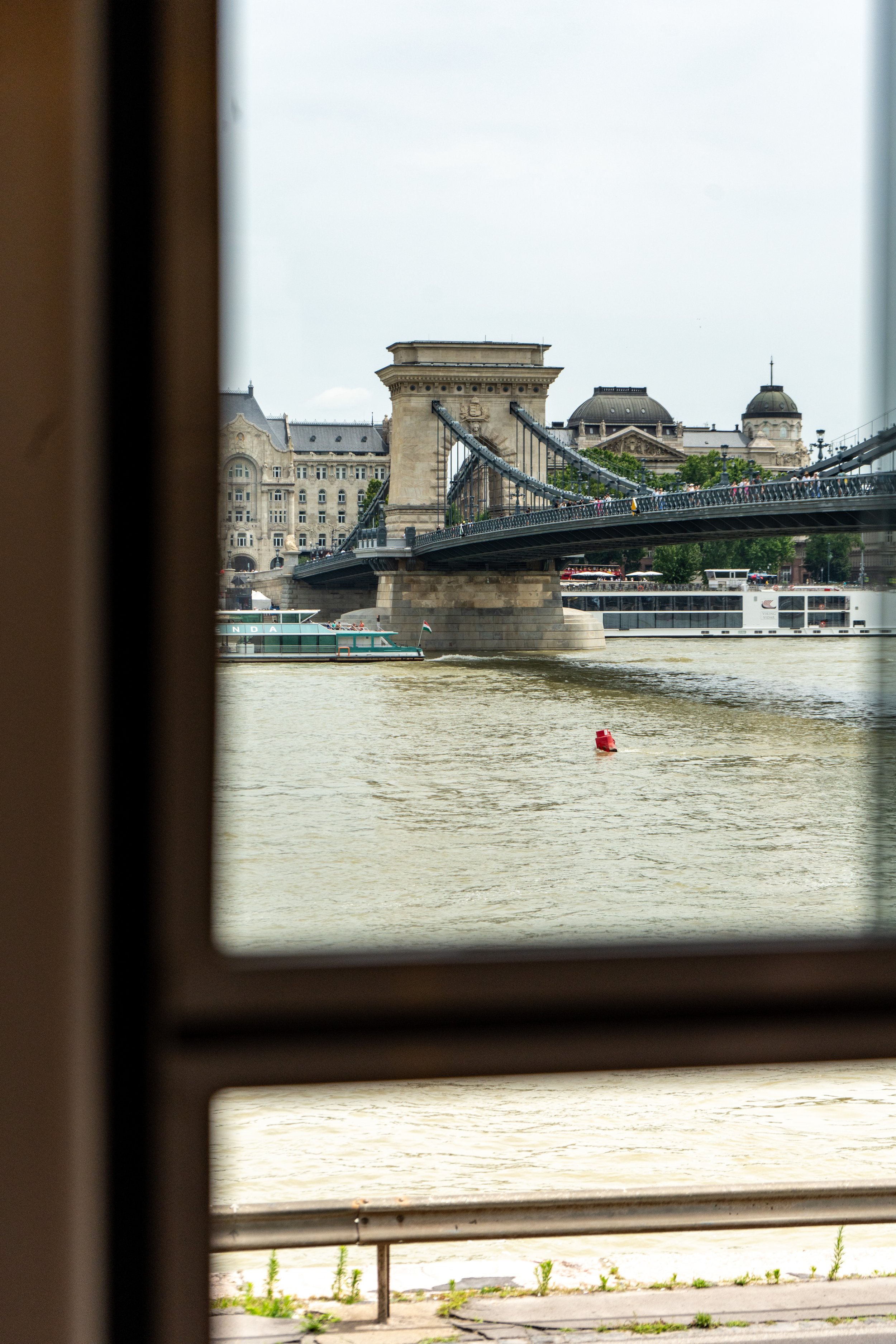 Chain Bridge over river in Budapest viewed through window