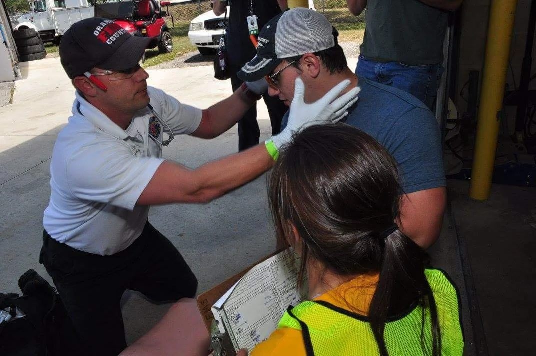 Chief Davis Assessing a Patient at a Medical Competition with his EMS Team