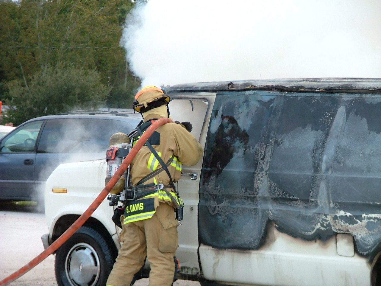 Firefighter Davis fighting a van fire
