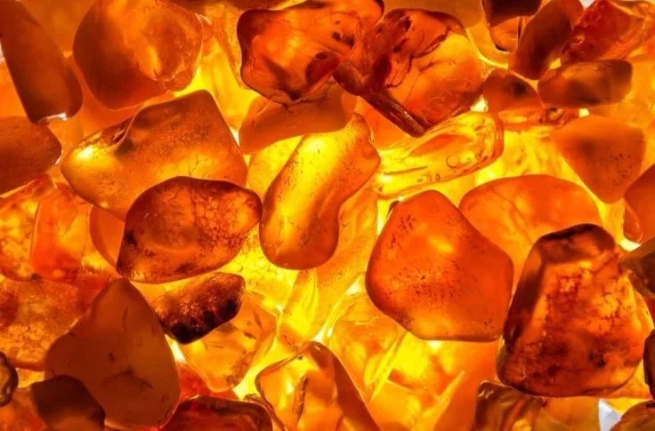 Close-up view of amber-colored stones or crystals with a glowing, translucent appearance.