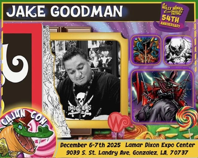 Black and white photograph of artist Jake Goodman at a signing table, surrounded by colorful merchandise and artwork at Calhoun Con, held December 6-7, 2025 at Lamar Dixon Expo Center in Gonzalez, Louisiana.
