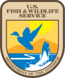 U.S. Fish & Wildlife Service badge with a blue bird, fish, and aquatic plants on a yellow background.